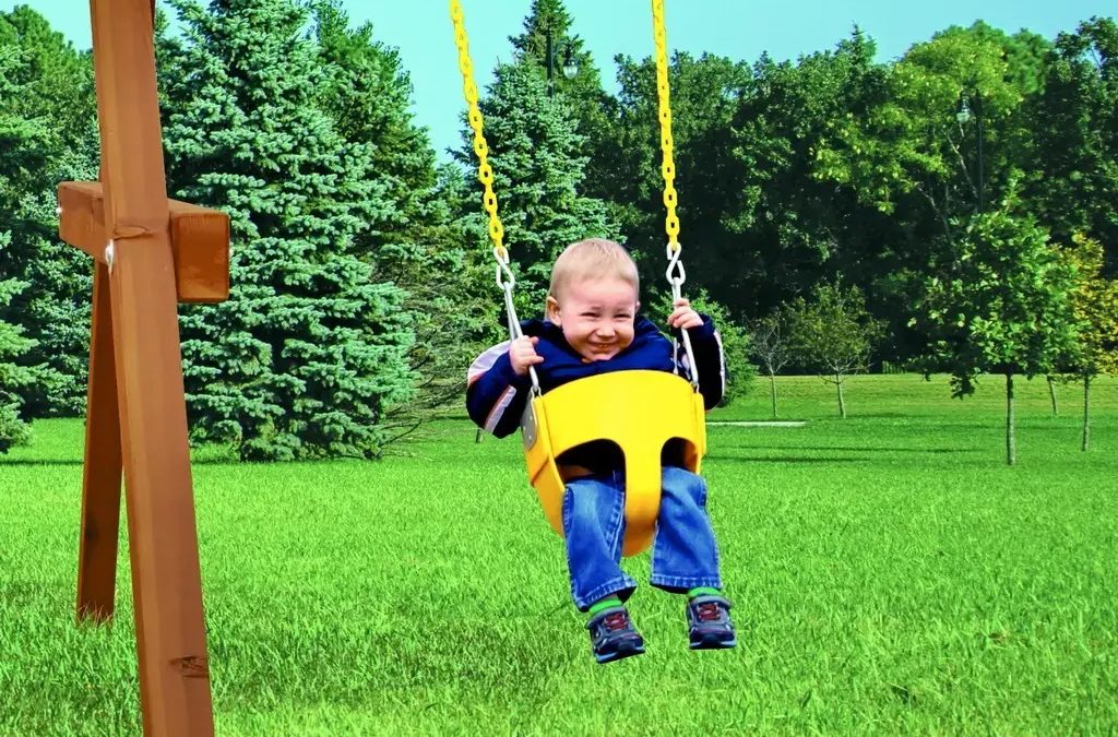 Small child in Rainbow Swing Set Full Bucket Swing