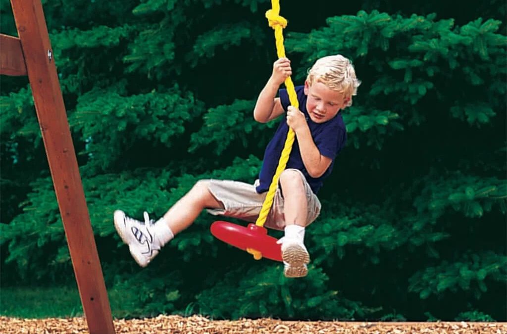 Little boy jumping onto Rainbow Swing Set Knotted Rope with Disc